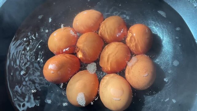 Hard-boiled eggs in hot, bubbling water. A simple egg-boiling. 