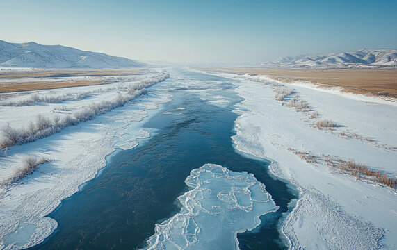 Intricate Frozen River Winding Through Snowy Mountain Landscape