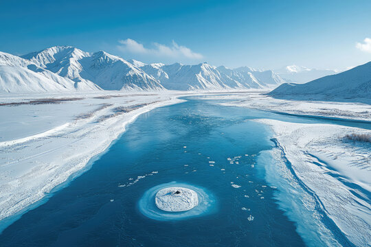 Snow-Capped Mountains Surrounding a Frozen Textured River