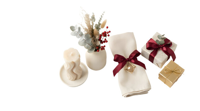 Elegant christmas table setting with a wavy candle, dried flower arrangement, napkin with a burgundy ribbon, and two gift boxes isolated on transparent background