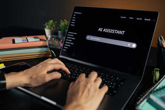 Person typing on laptop using ai assistant chatbot