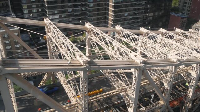 New York City Queensboro bridge architecture from Queens to Manhattan Midtown, United States. Urban public transport, tramway to Roosevelt island over East River. Metallic bridge road to East Side.