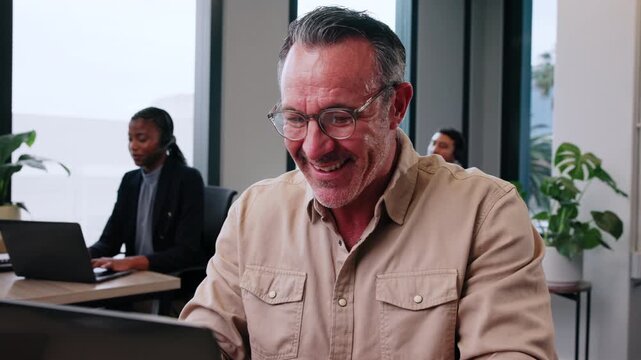 Man, realtor and happy in office with laptop, viewing booking and update property listing on website. Mature agent, tech and coworking in firm with reading or auction opportunity for extra commission