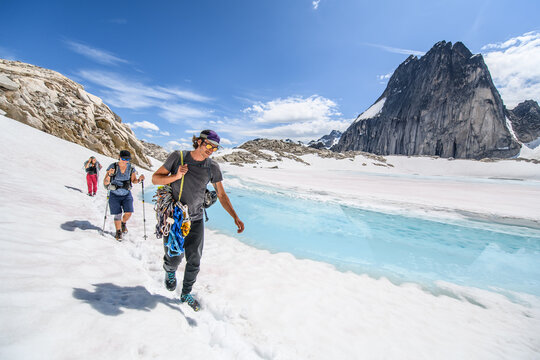 Three climbers hiking through a snowy mountain pass Bugaboo