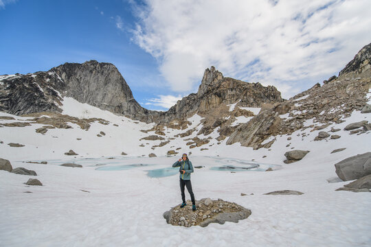 Hiker standing in a vast snowy alpine landscape, bugaboo