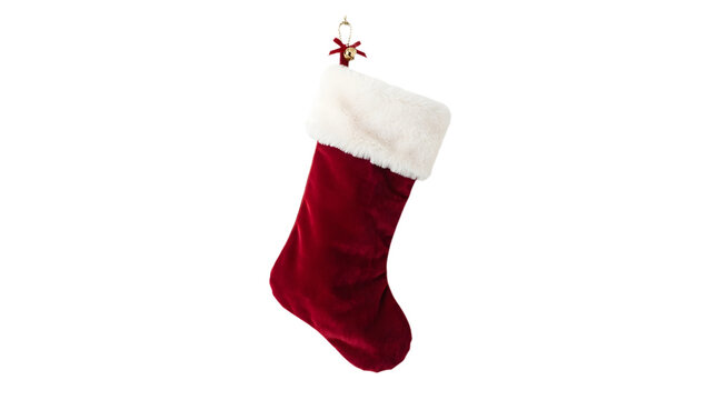 Red velvet christmas stocking with white faux fur trim and a decorative bell ornament, isolated on transparent background