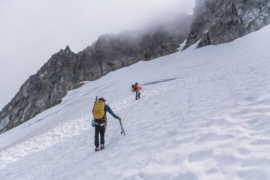 Roped Mountaineers Climbing Steep Snow Field in Tantalus Range