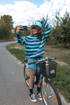 Two modern teenage girls enjoying a bicycle ride in the countrys