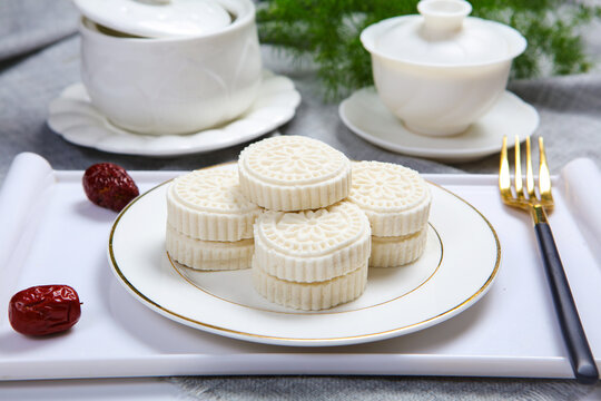 White Steamed Rice Cakes On Floral Plate With Bamboo Tea Tray
