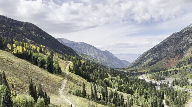 Point of view from an aerial tramway overlooking a vast rugged mountain range and deep valley.