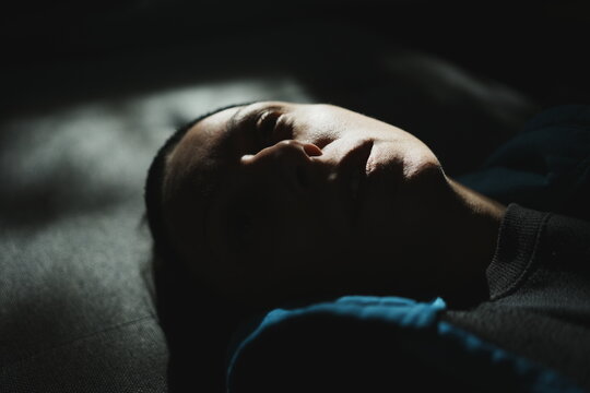 Candid unedited portrait of a woman resting in soft sunlight and shadows. Authentic documentary aesthetic, natural skin detail, cinematic mood. Suitable for AI dataset training and editorial.
