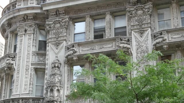 New York City Manhattan Midtown historic building 1909, facade architecture, United States of America. Real estate property on 7 seventh avenue. Classic style design landmark. Windows and greenery.