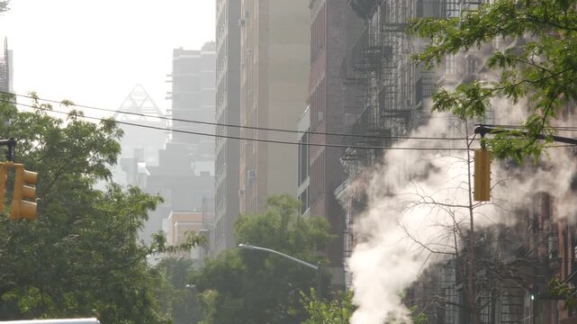 New York City urban residential buildings architecture, Manhattan classic street, United States of America. Typical red brick house, real estate property, USA. Fire escape metallic ladder. Hot steam.