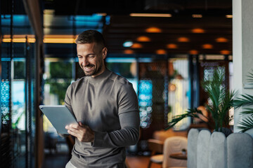 Smiling man communicating with modern digital tablet technology
