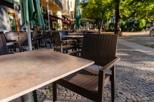 Outdoor seating area with tables and chairs in city park during day