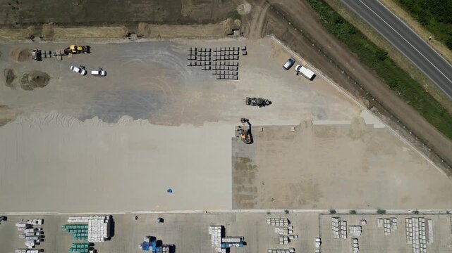 Heavy machinery laying interlocking concrete pavers
