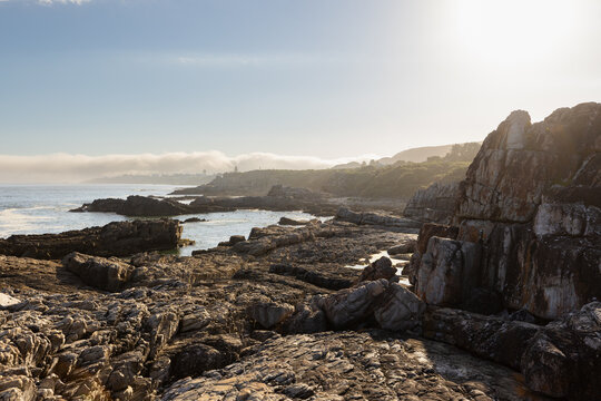 beautiful rocky coastline and rock formations of Hermanus, South Africa in late afternoon light