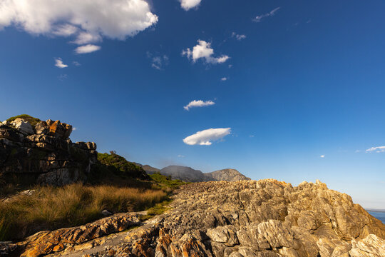 beautiful rocky coastline and rock formations of Hermanus, South Africa in late afternoon light