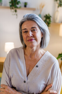 Portrait of mature white woman with gray hair indoors at home