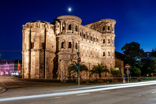 Illuminated Porta Nigra stands in Trier during blue hour