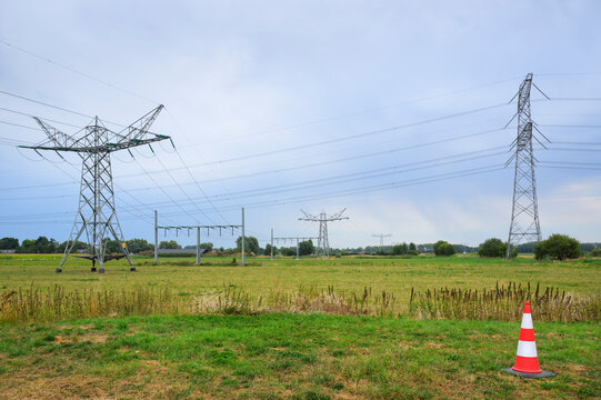 Two crossing power lines in a rural field in the Netherlands
