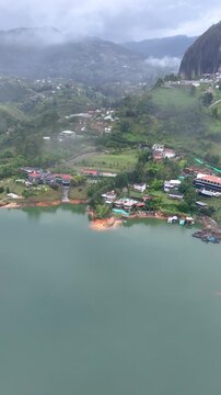 Guatap&eacute; Featuring El Pe&ntilde;&oacute;n de Guatap&eacute; Monolith and Scenic Reservoir Landscape in Antioquia, Colombia. Establishing Shot. Aerial View. Vertical Video.