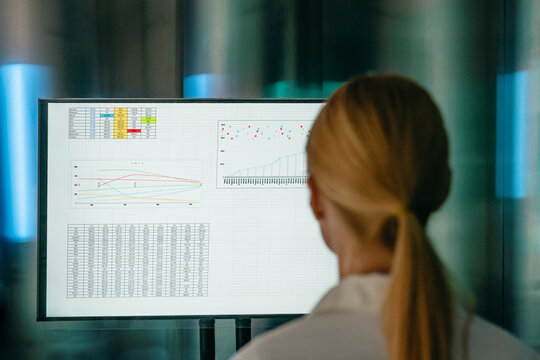 Businesswoman looks at data analysis on a modern digital screen