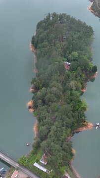 Guatap&eacute; Featuring El Pe&ntilde;&oacute;n de Guatap&eacute; Monolith and Scenic Reservoir Landscape in Antioquia, Colombia. Establishing Shot. Aerial View. Vertical Video.