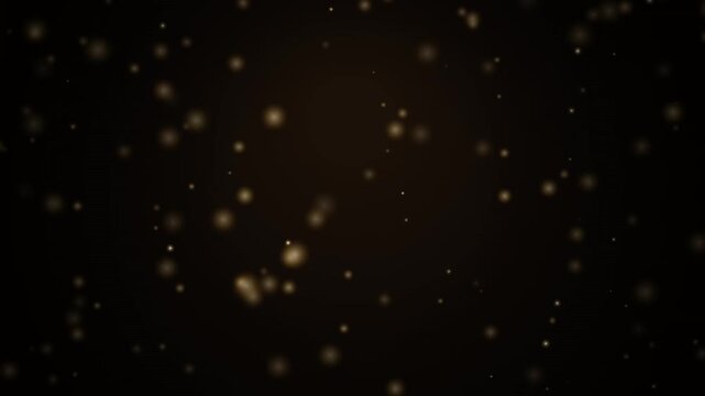 Abstract golden glowing particles floating softly in dark atmosphere for motion background.