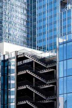 Modern glass office buildings with a zigzag staircase creating graphic urban architecture and a strong business setting around the office buildings