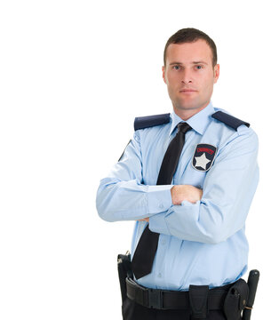 Half length portrait of professional male security guard without cap with arms crossed against white background.   