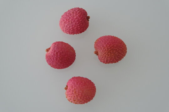 lychee fruit. red lychee fruit on white. lychee is a small tropical fruit from the soapberry family
