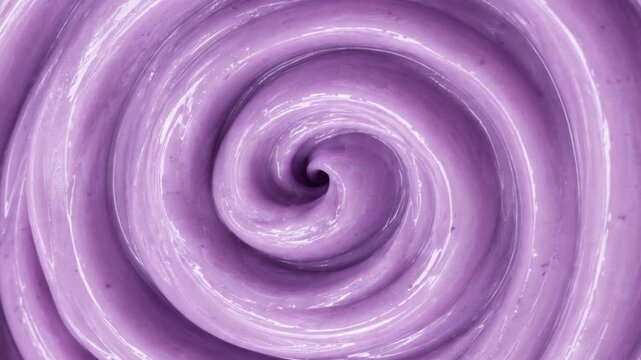 Abstract swirling spiral pattern of soft purple lavender ice cream or smoothie background Top view macro swirl texture of creamy purple blueberry yogurt with video play button