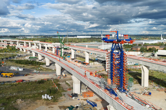 Aerial view of High Speed Rail construction featuring a large launching gantry crane on a concrete viaduct in the United Kingdom.