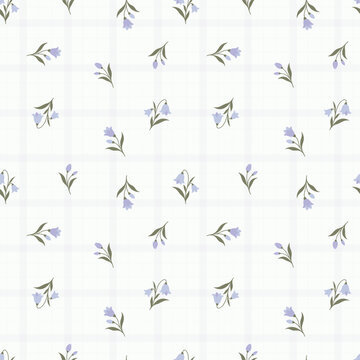 Charming purple blue ditsy floral seamless pattern on subtle windowpane check grid background for rustic summer textiles wallpaper