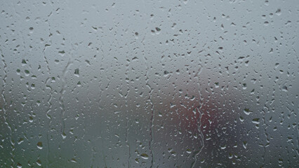 Rain drop hitting window glass and sliding down © GCapture
