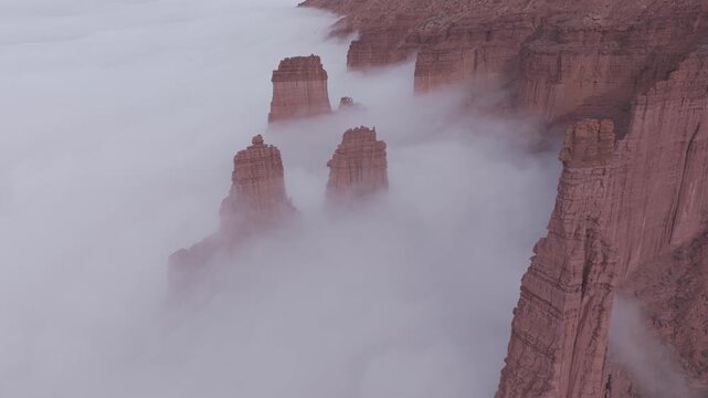 Fisher Towers rock spires surrounded by valley clouds