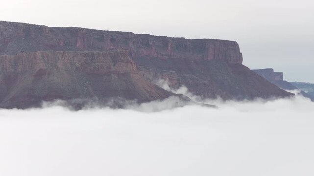 Sandstone mesa rising above a sea of low clouds