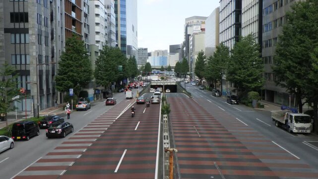 Chiyoda, Tokyo Japan - October 4, 2026: Traffic flowing into an underpass tunnel on a multi-lane urban avenue (tokyo-underpass-video-20261004)