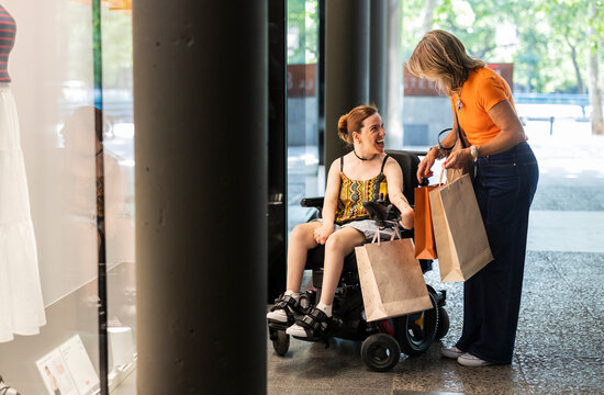Women with disability enjoying shopping together at store
