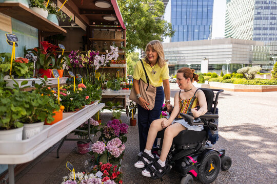 Women shopping for plants at outdoor flower market