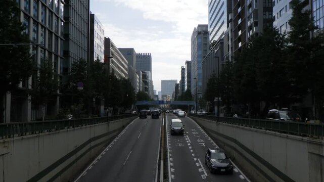 Chiyoda, Tokyo Japan - October 4, 2026: Straight urban avenue with cars exiting a tunnel underpass towards city center (tokyo-underpass-wide-20261004)