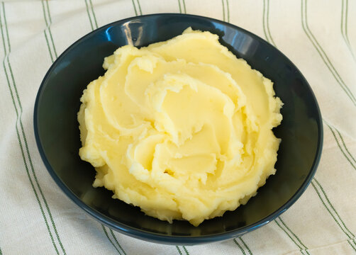 Mash potato in black bowl closeup
