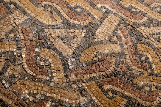 ancient Roman mosaic type pavement background with a geometric pattern in ocher tones