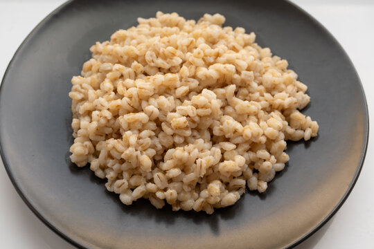 Boiled pearl barley, cooked wheat groats close up