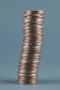 Tall stack of copper coins on blue background