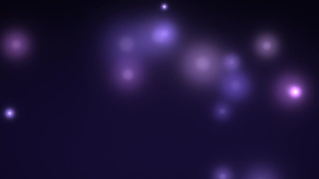 Purple sparkles drift and shimmer across a dark abstract background glitter luminescence particles dust violet lavender