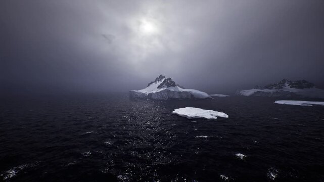 melting glacier reflecting pale light, sea dotted with floes and shimmer while thin mist rises, conveying warming waters and fragile polar landscape under heavy