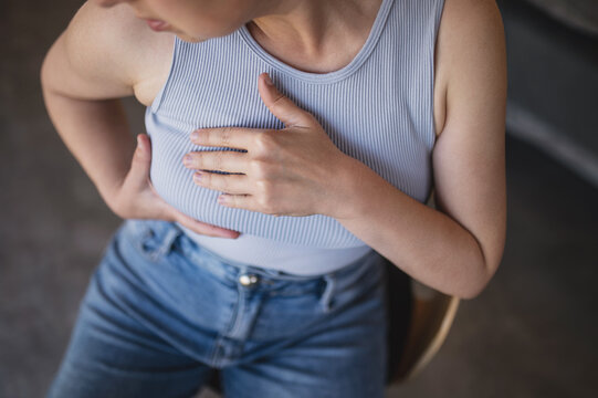 Unrecognizable woman performing breast self-examination at home, symbolizing October Breast Cancer Awareness Month, breast cancer prevention, early detection, screening and women&rsquo;s health awareness