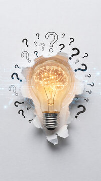 Lightbulb with brain inside emerging from questions symbolizing creative thinking process